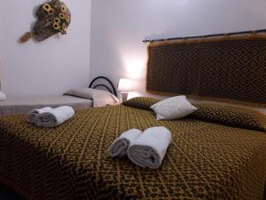ポルト・トッレスにあるAgriturismo Quattro Moriのベッドルーム1室(ベッド2台、ベッド上にタオル付)