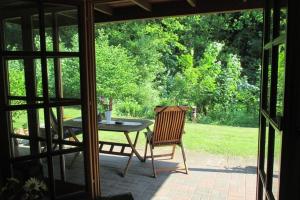 a patio with a table and a chair in a yard at Haus am Wald Klingberg in Klingberg