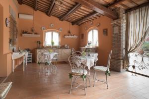 a kitchen and dining room with tables and chairs at Il Poggianino in Poggio Berni +29 photos