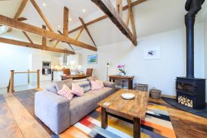 a living room with a couch and a wood stove at The Stables and Hayloft in Ledbury