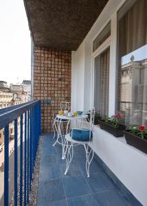 a patio with a table and chairs on a balcony at Take 5 in Belgrade