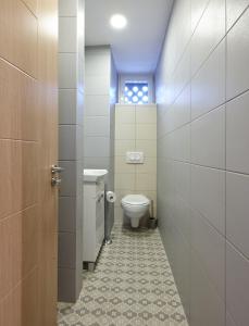 a bathroom with a toilet and a sink at Take 5 in Belgrade +14 photos