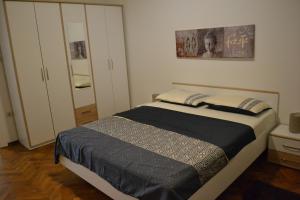 a bedroom with a bed and a closet at Alex in Rijeka