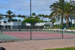 a tennis court with a fence on top of it at Bungalow en Playa del Ingles in Playa del Ingles