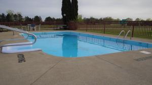 a swimming pool with blue water in a park at Stay Inn in Port Clinton
