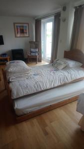 a large bed in a bedroom with a window at Rebels Hide -Self check in apartment in Penrith