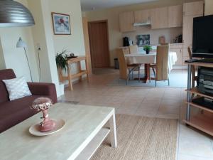 a living room with a couch and a coffee table at FeWo am Pohlsee in Langwedel +9 photos