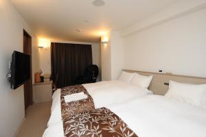 Cama ou camas em um quarto em Hotel Sunriver Shimanto