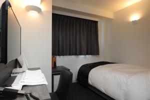 Uma TV ou centro de entretenimento em Hotel Sunriver Shimanto