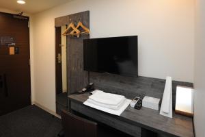 Uma TV ou centro de entretenimento em Hotel Sunriver Shimanto