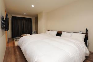 Cama ou camas em um quarto em Hotel Sunriver Shimanto