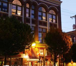 a large building with american flags in front of it at The Palace Hotel in Port Townsend