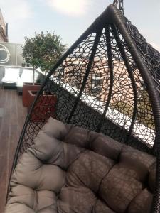 a hanging hammock with a couch in a room at Luxury 3 Bedroom Penthouse With Private Garage in Braga