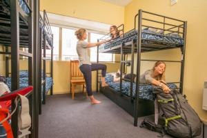 a woman and a child are in a bunk bed at Hobart Central YHA in Hobart