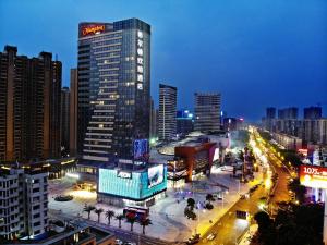 a city skyline at night with a tall building at Hampton By Hilton Foshan Sanshui in Foshan