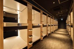 a row of lockers in a locker room at Cabin & Capsule Hotel J-SHIP Osaka Namba in Osaka