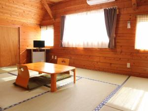 a dining room with a table and a window at Minshuku Manten in Yakushima