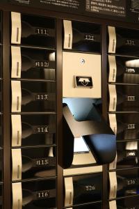 a rack of servers with a chair in it at Cabin & Capsule Hotel J-SHIP Osaka Namba in Osaka