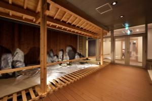 a room filled with lots of stuffed animals on display at Cabin & Capsule Hotel J-SHIP Osaka Namba in Osaka