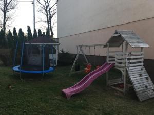 a playground with a slide and a swing set at Apartamenty AP 1 in Częstochowa
