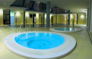 a large blue bath tub in a building at Apartamenty Maritimo in Kołobrzeg