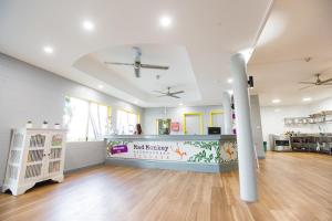 a large room with a kitchen and a counter in a room at Mad Monkey Village in Cairns