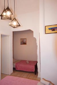 a room with a bed and a lamp at Apartments Mia in Dubrovnik