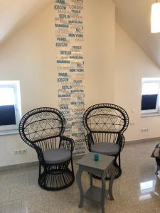 two chairs and a table in a room with writing on the wall at Burgblick in Bernkastel-Kues