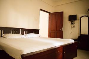 Postel nebo postele na pokoji v ubytování Ruby Residency