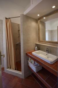 a bathroom with a sink and a shower and a mirror at Apartments Mia in Dubrovnik