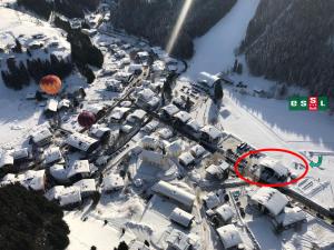 an aerial view of a snow covered village with a hot air balloon at Essl in Filzmoos in Filzmoos