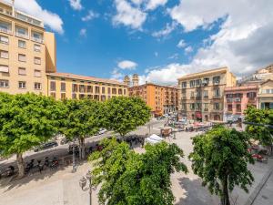 a city street with trees and buildings in a city at Sardinia Home Design in Cagliari