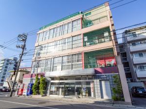 a tall building on a city street at Business Hotel New Nagawajima in Fukuyama