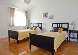 a bedroom with two beds and a window at Apartments Katarina with swimming pool in Stobreč +41 photos