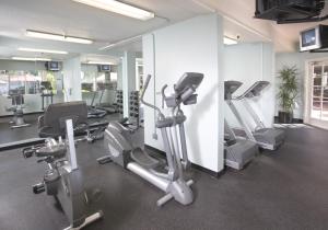 a gym with treadmills and ellipticals in a room at Handlery Hotel San Diego in San Diego