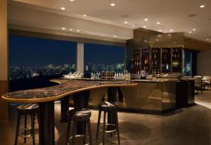 a bar in a hotel with a view of a city at Odakyu Hotel Century Southern Tower in Tokyo