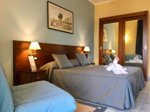 Postel nebo postele na pokoji v ubytování Grand Hotel L'Approdo