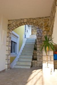 a stone staircase in a house with a stone wall at Apartments Gran Sasso in Ulcinj