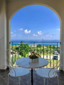 a table and chairs on a balcony with a view of the ocean at Residenza Azzurra in Tropea