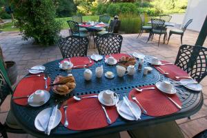 a blue table with plates and utensils on it at Golden Hill Guest House in Somerset West