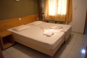Postel nebo postele na pokoji v ubytování Hotel Paralia