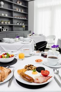 a table with a breakfast of eggs and toast at Coast B&B in Bexhill