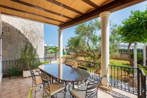 patio con mesa y sillas en el balcón en Villa Tortugas, 5 min ibiza City, en Ibiza