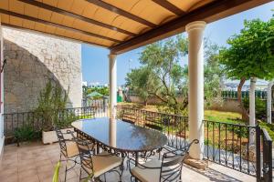 a patio with a table and chairs on a balcony at Villa Tortugas, 5 min ibiza City in Ibiza Town