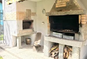 a kitchen with two stone ovens on a patio at Casa Grace in Brione +6 photos