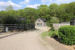 a driveway with a fence and a house at Stefjes Holiday Home in Dilsen-Stokkem