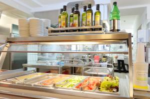 a restaurant kitchen with bottles of wine and food at Jugendherberge Wien - Myrthengasse in Vienna