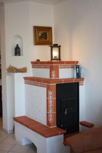 a fireplace in a living room with a fire place at Ferienwohnungen am Wald in Lieser
