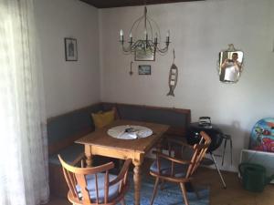 a dining room with a wooden table and chairs at Ferienbungalow in Döbriach Top 8 in Döbriach