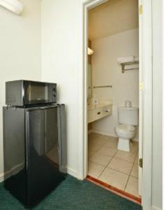 a bathroom with a toilet and a microwave at America's Best Value Inn-Marion in Marion